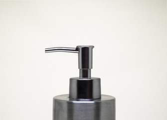 Metallic, reflective dispenser hood for hygiene products, liquid soap, white background 