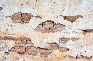 Old white wall cracked red brick surface background : Closeup