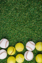 flat lay with arrangement of tennis and baseball balls on green grass