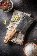 Old meat butcher on dark concrete board