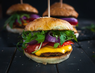 Close-up of homemade fresh burgers on dark background