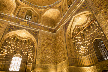 Fototapeta na wymiar Amir Temur (Tamerlan) tomb in Samarkand, Uzbekistan. Wall's and ceiling golden mosaic decoration in Persian and Arabic ornaments and writing, Samarkand.