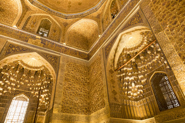 Fototapeta na wymiar Amir Temur (Tamerlan) tomb in Samarkand, Uzbekistan. Wall's and ceiling golden mosaic decoration in Persian and Arabic ornaments and writing, Samarkand.