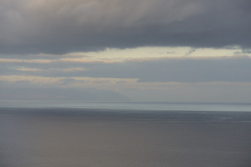 Blurred sunshine reflections in ocean and clouds over Canary Islands.