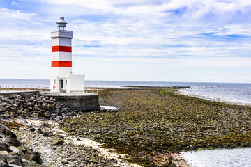 Iceland lighthouse against stormy clouds 