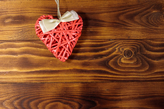 Pink heart on wooden background