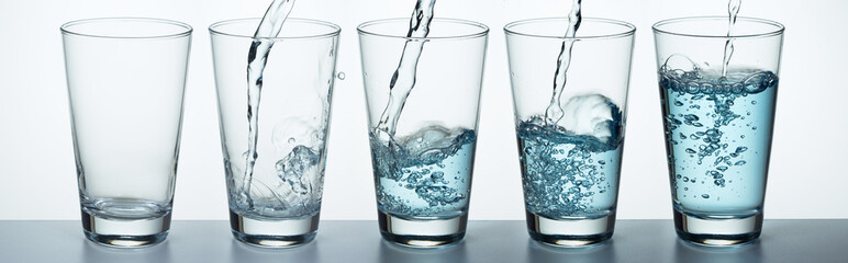 Glass is filling up with water - obrazy, fototapety, plakaty