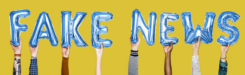 Blue alphabet helium balloons forming the text fake news
