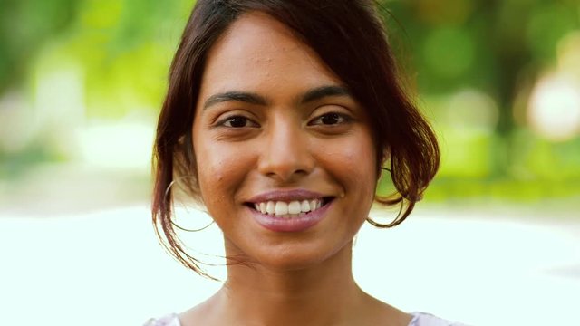 people concept - portrait of happy smiling indian woman outdoors