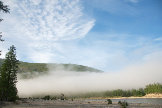 Morning mist on a mountain river. Kalar River, Stanovoy Highlands, Russia.