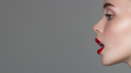 Naklejka premium Perfect smile. Sexy Lips. Beauty Red Lip Makeup Detail. Beautiful Make-up Closeup. Sensual Open Mouth. lipstick or Lipgloss. Kiss. Beauty Model Woman