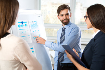 Businessman explains to colleagues a new project