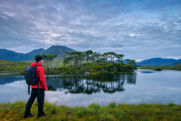 Fototapeta na wymiar Young hiker at the Pine Island in Derryclare Lough