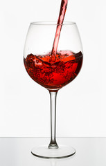 Beautiful splash of red wine in a glass