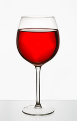 Glass of wine in a glass on a white background