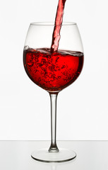 Beautiful splash of red wine in a glass