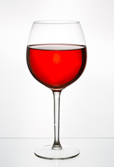 Glass of wine in a glass on a white background
