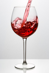 Beautiful splash of red wine in a glass