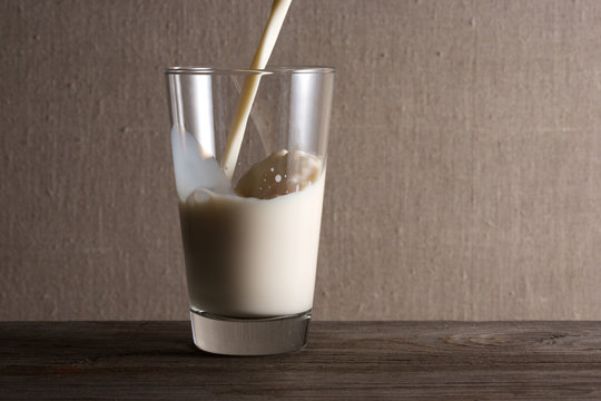 Fresh milk is poured into a glass.