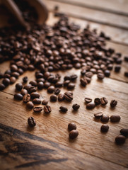 Close up of coffee beans on wooden background 