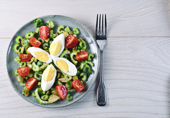 Celery salad with egg, olive and cherry tomato