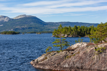 Blue lake with stony shores in the mountain valley, Telemark region, Southern Norway