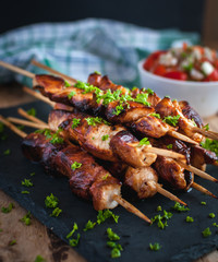 Close-up of homemade honey and beer BBQ chicken skewers with fresh parsley