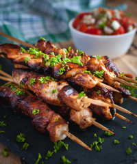 Close-up of homemade honey and beer BBQ chicken skewers with fresh parsley