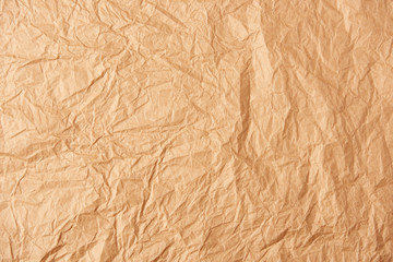 full frame of beige crumpled paper as background