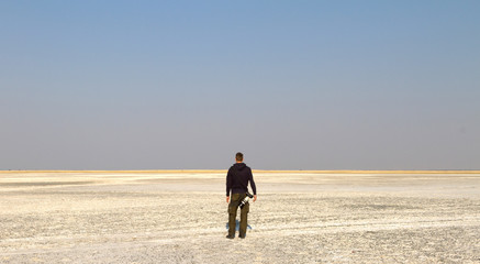 Fototapeta na wymiar Unrecognisable photographer staring at the plains of the Makgadikgadi