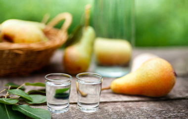 Shot glass with fresh pear on table