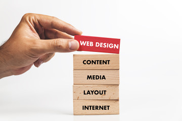 Businessman Building WEB DESIGN concept with Wooden Blocks
