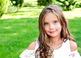 Portrait of adorable smiling little girl child outdoors