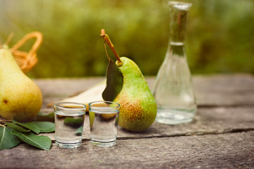 Fruit brandy in shot glass with raw pears