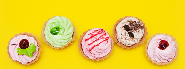 Cakes on yellow background.


