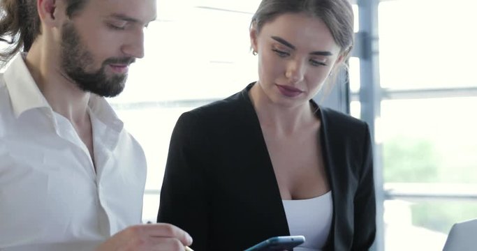 Business Office. Man With Phone And Woman Working At Computer