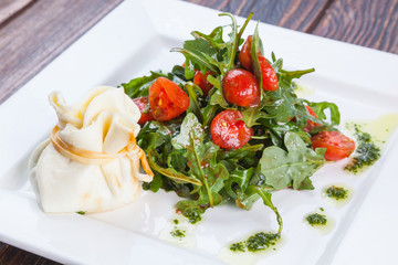 Salad with cherry tomatoes and Arugula with cheese bag