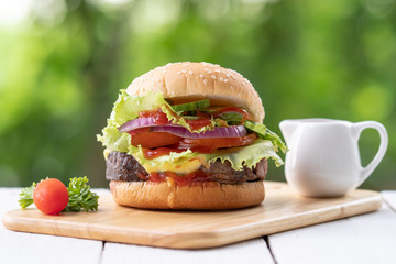 Tasty burger on cutting bord with bokeh background