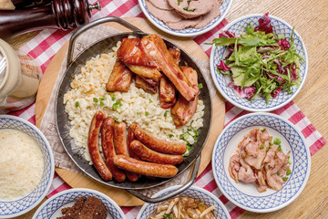 Oktoberfest food menu: sausages, fried bacon, pork ears, salad.