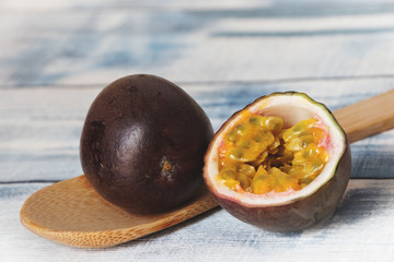 passion fruit on wooden table with spoon