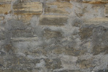 gray brown stone texture of plaster and kipiches on the old wall