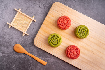 Red and green Mid-Autumn festival mooncakes are displayed