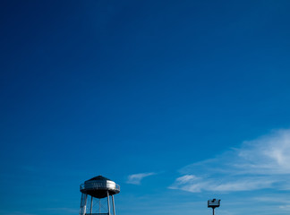 Top parts of the water and light towers. Selective focus. Copy space.