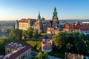 Historic royal Wawel castle and cathedral in Cracow, Poland.  Aerial view in sunrise light early in the morning - obrazy, fototapety, plakaty