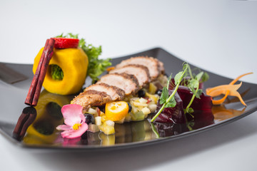 Fresh salad from duck fille with fruits, jellies, green and cinnamon