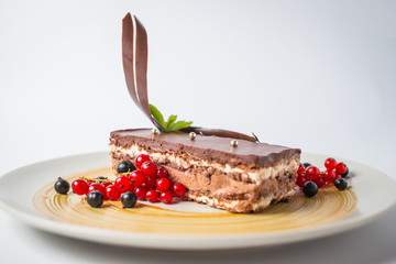 Sweet milk chocolate cake with red and black berries and jewerly