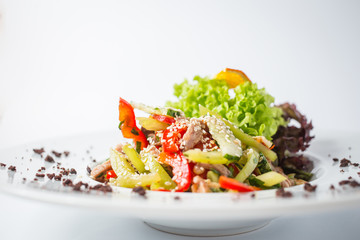 Asian fresh salad with orange, green, cucumber, pepper and thai sauce
