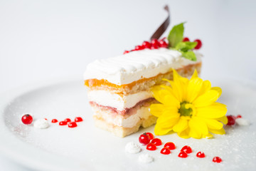 Sweet fruity cake with red berries and yellow flower