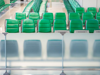 Fototapeta premium Green airport waiting chairs or seating within the terminal.
