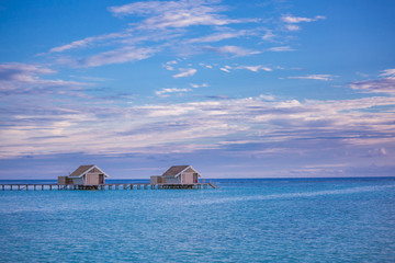 Beautiful beach with water bungalows at Maldives. Perfect beach panorama for summer travel destination banner background